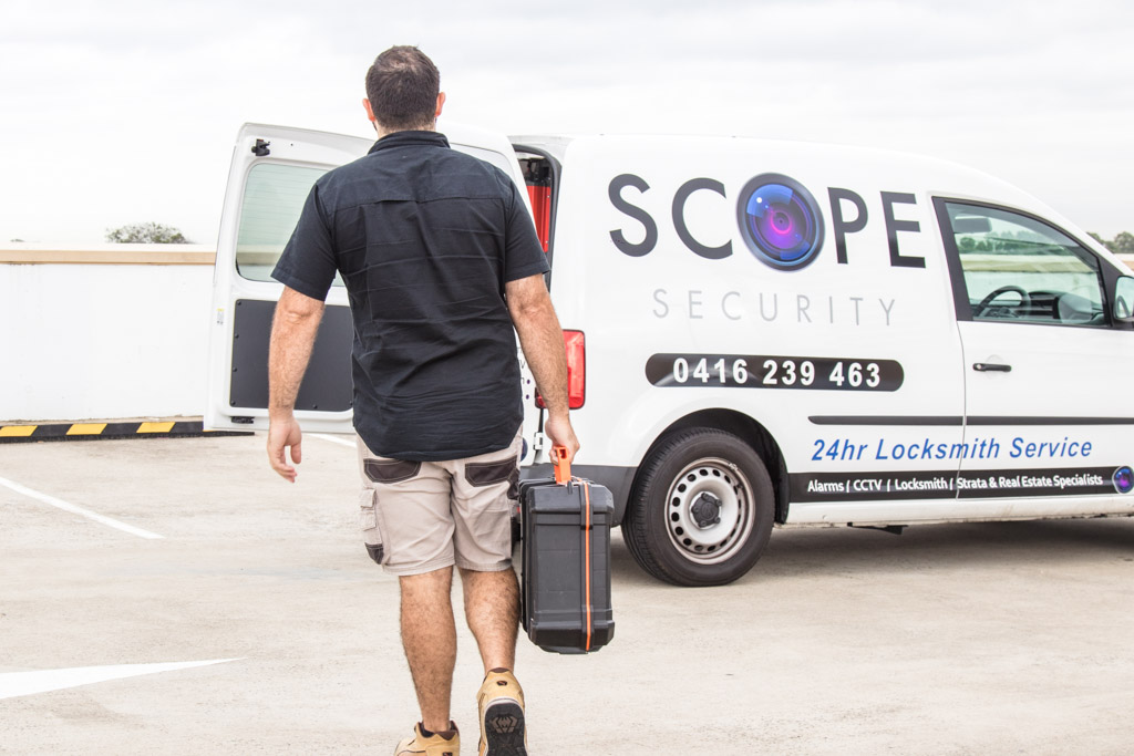 Scope Security locksmith walking to mobile van